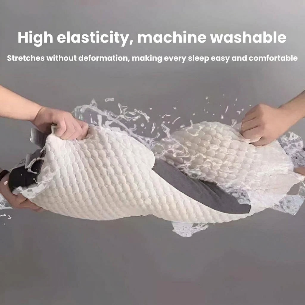 A white textured pillow being stretched by two hands against a gray background, with text reading 'High elasticity, machine washable' and 'Pulls without deformation, making every sleep easy and comfortable.'.