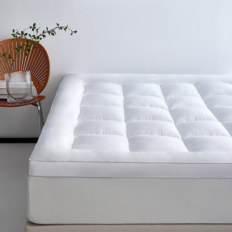 WolkenTopper in White on a bed