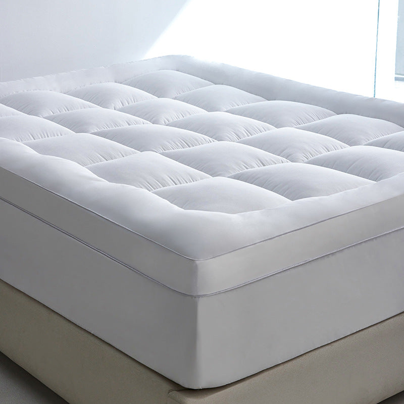Side view of WolkenTopper in White on a bed