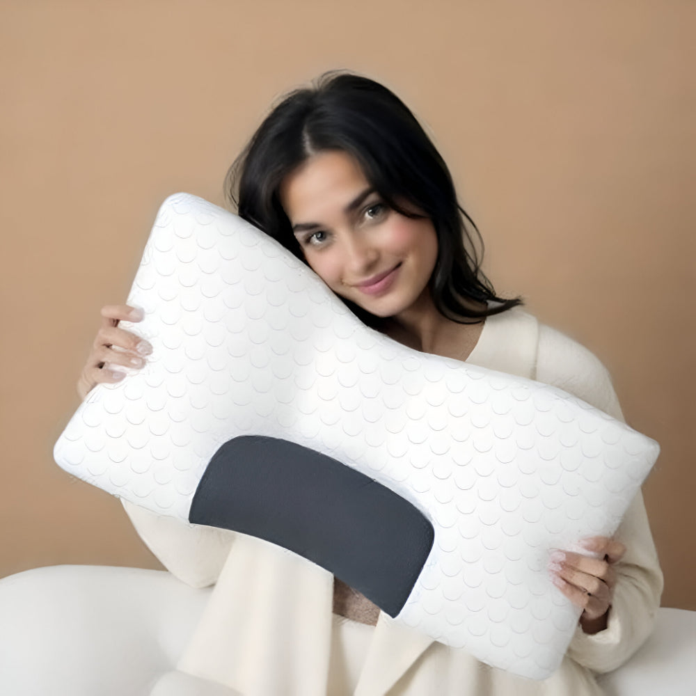 Woman holding the ergonomic pillow against her neck.