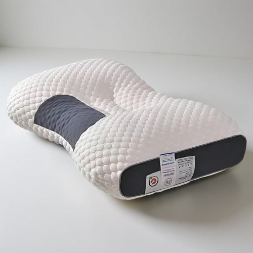 Contour pillow shown from the side, with a care label on the back panel.