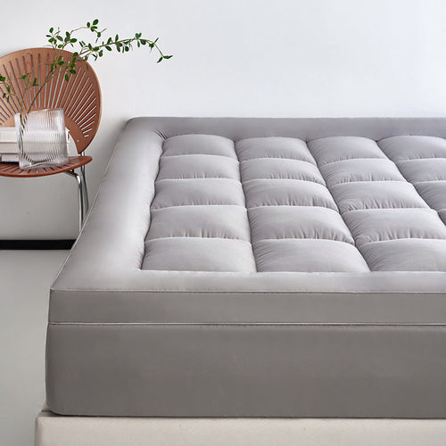 WolkenTopper in Grey on a bed